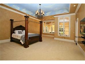 Expansive master suite with custom painted ceiling and large win