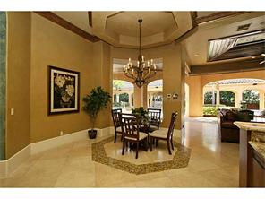 Breakfast nook featuring tray ceiling and handset stone floor wi