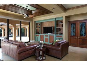 Family Room with custom cabinets, cypress tray ceiling, recessed